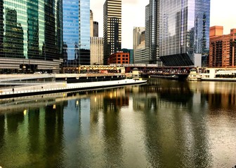 Colorful reflection of cityscape on a freezing Chicago River in winter during rush hour.
