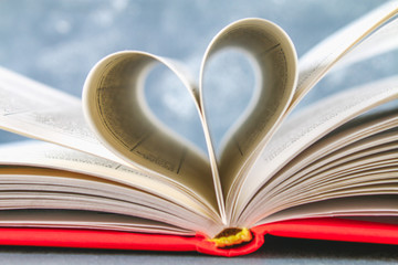 The pages of the book in the red cover are made in the form of a heart. The concept of Valentine's Day.