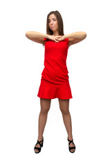 Happy surprised girl in red dress in stockings and in high heels shoes is standing is dreaming and is dancing on isolated on white background.