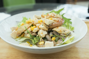 Plates with chicken salad on the table