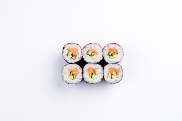 Classic mini sushi rolls with salmon and cucumber top view.