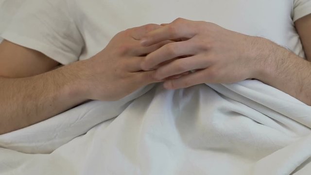 Nervous male hands blanket, sleep disorder, anxiety, prostatitis health problem