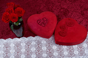 Valentine or Love Themed Shot with Red Hearts, Lace, Red Roses on Crushed Red Velvet Background