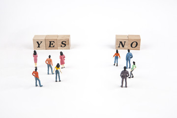 people standing at yes or no lettering cube on white background