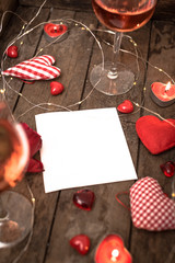 Preparations for Valentine's Day: a notebook for congratulation or sweet notes, gift, candy in the form of hearts, red ribbon and top view, copy space