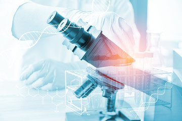 double exposure of microscope and science laboratory test tube with chromosome on virtual screen , science research concept