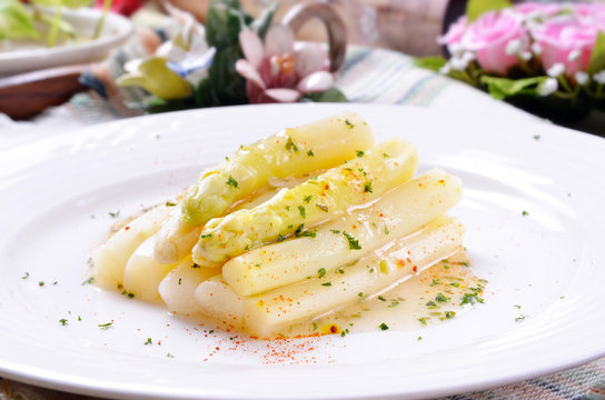  Tasty white asparagus on white plate        