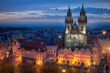 Fototapeta na wymiar View from Town Hall Clock Tower to Church of Our Lady before Tyn on Old Town Square and Traditional old buildings at night after sunset in Prague, Czech Republic