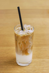 Iced coffee cafe latte on wooden table
