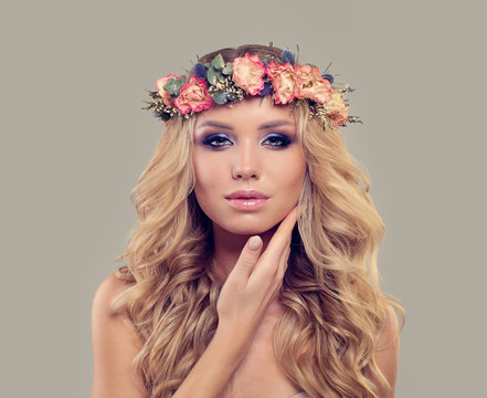 Young Perfect Woman with Spring Flowers. Pretty Female Face. Facial Treatment, Aesthetic Medicine and Cosmetology Concept