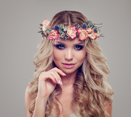 Summer Portrait of Beautiful Woman Fashion Model wearing Flowers Wreath. Blonde Curly Hair, Makeup