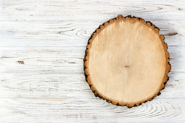 Fototapeta na wymiar Tree stump round cut with annual rings on wooden background. top view with copy space