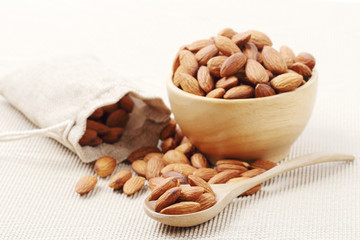 Dry of almonds nuts in a wooden spoon