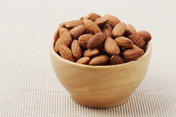 almonds nuts in a wooden bowl