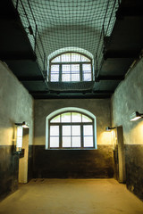 Dark jail dirty corridor with windows and doors