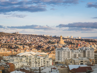 Fototapeta premium aerial view of city in Georgia and sky at sunset