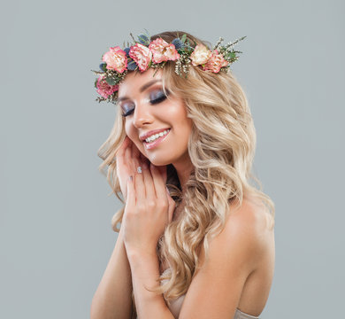 Beautiful Smiling Lady with Flowers, Wavy Hair, Makeup and Manicured Hands. Perfect Spring Woman