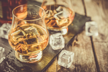 Whiskey on rustic wood background