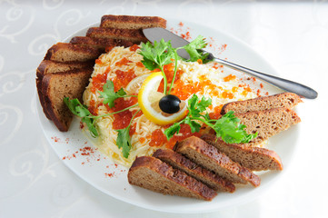 Two sandwiches with butter and red salmon caviar on white bread lies on white round plate on wooden background top view