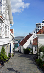 Fototapeta na wymiar Scenic view of street with traditional white wooden houses in Gamle Stavanger in Rogaland, Norway, sunny day with blue sky