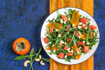 Fresh salad with salmon and persimmon