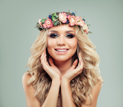 Smiling Young Woman with Flowers. Cute Female Face
