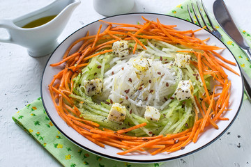 Vitamin salad from carrots, daikon, cheese and radishes