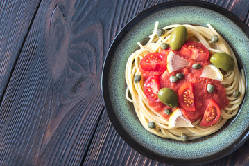 Pasta with tomato sauce, olives and capers