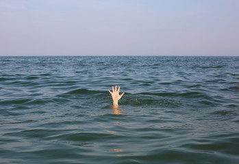 hand of the person who is about to drown in the ocean