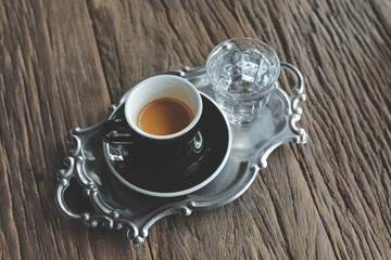 Hot coffee on wood background.
