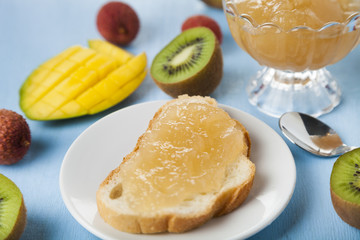 Jam of tropical fruits on bread