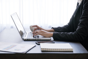 woman working with laptop,working on desk,laptop computer working by business woman,Office wokeplace environment,woman hands at work,Typing laptop keyboard.