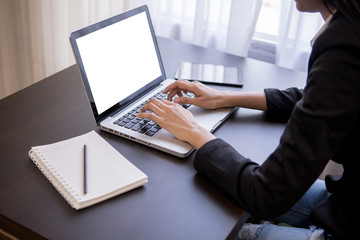 woman working with laptop mock up,working on desk,laptop computer working by business woman,Office wokeplace environment,woman hands at work,Typing laptop keyboard.