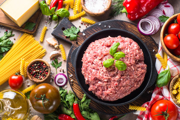 Minced meat, pasta and vegetables. Food background. Top view.