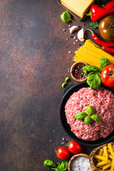 Minced meat, pasta and vegetables. Food background. Ingredients for cooking. Top view copy space.