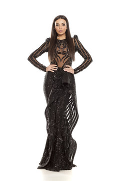 young beautiful woman in a black evening dress on a white background