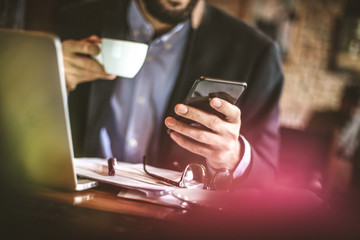 Business man take a break surfing online on smart phone.