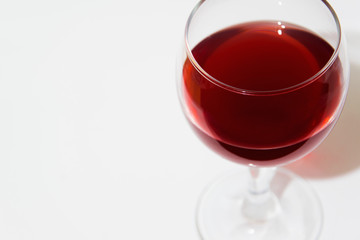 Isolated elegant glass of red wine on white background with space for menu or text