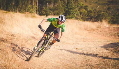 Wide angle view of a mountain biker speeding downhill on a mountain bike track in the woods © Dewald
