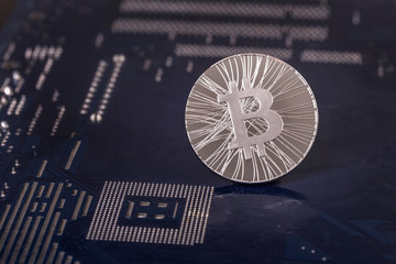 Coin bitcoin on the motherboard closeup.