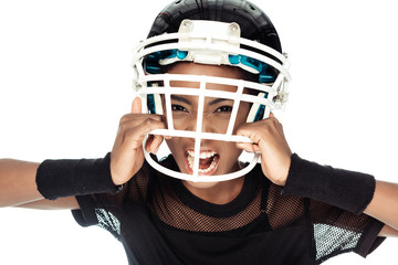 high angle view of agressive female american football player trying to take off her helmet isolated on white