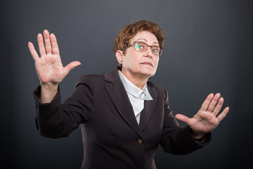 Business senior lady holding hands like explaining something