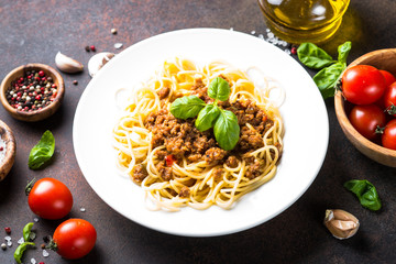 Spaghetti bolognese  on dark stone table.