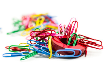 Magnet covered by paper clips isolated on a white background