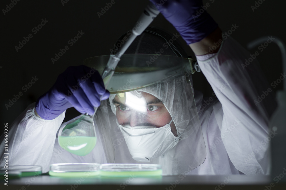 Poster life scientist researching in bio hazard laboratory. focused life science professional working on ex