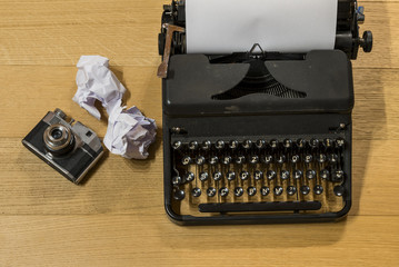 photo of a desk with a typewriter and a camera.