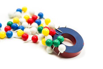 circle magnet attracting paper pins isolated on white