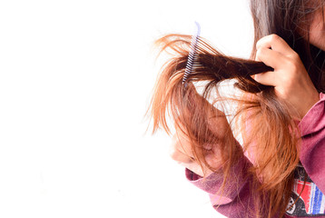 Obraz premium Combing with brush and pulls long hair. Daily preparation for looking nice, Long Disheveled Hair,Holding Messy Unbrushed Dry Hair In Hands. Hair Damage, Health And Beauty Concept.