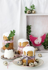 Easter still life with Easter cake kulich, paskha and painted eggs on a light background.