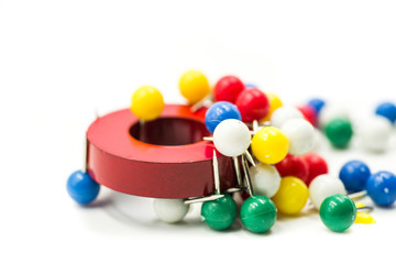 circle magnet attracting paper pins isolated on white